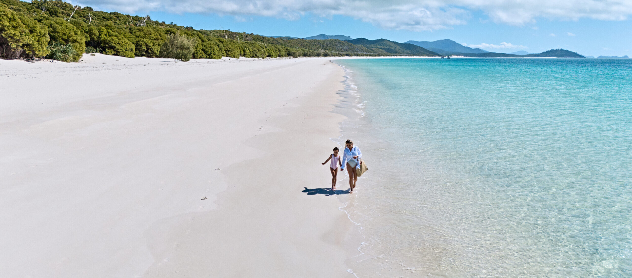 Mother and Daughter exploring the shoreline of Whitehaven Beach